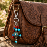boho purse charm hanging on a floral leather bag