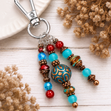 southwestern styled purse charm laying on white wood table