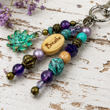 Inspirational Purse charm with a wooden 'Breathe' charm on a rustic wooden surface.