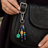 Black leather bag with decorative yoga purse charm featuring beads and charms