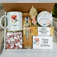 Fifty and fabulous: Personalized name mug, coffee, goodies, engraved spoon, and candle in a birthday surprise for her.