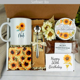 Sunflower themed Cheers to five decades: Women's birthday gift basket featuring a personalized name mug, gourmet coffee, sweet goodies, engraved spoon, and candle.