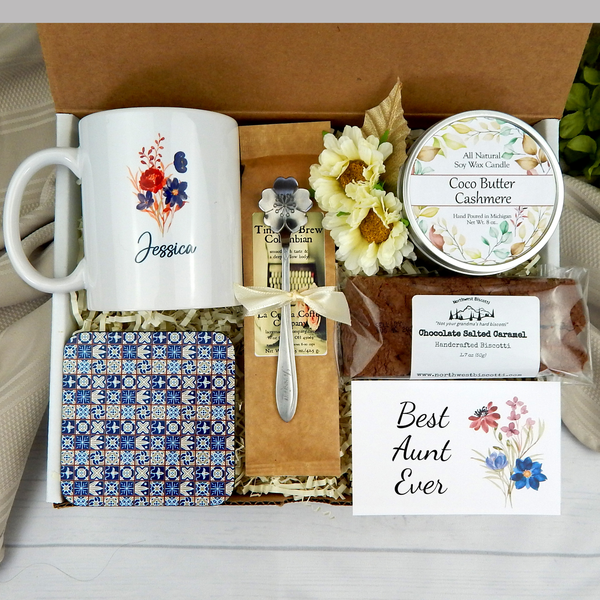 Celebrating Aunt's Delight: Gift basket for women with custom mug, coffee, goodies, engraved spoon, and candle.