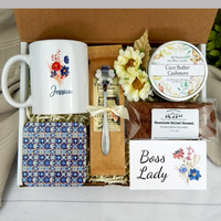 Empowering the boss lady: Manager's gift basket with customized mug, coffee, goodies, engraved spoon, and candle.