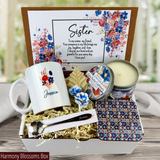 Show your sister you care with a personalized gift basket: mug, spoon, coaster, candle, and a heartfelt message.
