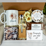 Achieving greatness: Gift basket featuring a personalized name mug, candle, engraved spoon, biscotti, and coffee for accomplishments in a coffee lover theme.