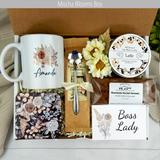 Boss lady's success: Women's manager gift basket featuring coffee, a customized mug, sweet treats, engraved spoon, and a candle.