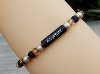 black and beige engraved bracelet