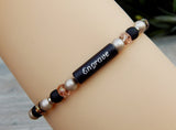 black and beige engraved bracelet