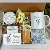 Thoughtful care package for your niece: Personalized name mug, coffee, goodies, engraved spoon, and candle.