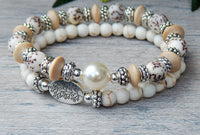 stacked white beaded bracelets